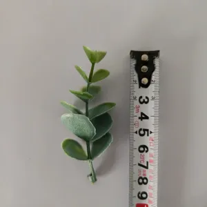Green artificial eucalyptus leaf detail, PVC plant stem for DIY floral arrangement crafts.