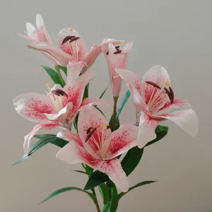 Close-up of artificial pink lily flower, realistic petal texture and vivid pink dots.