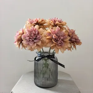 Vintage artificial dahlia flower bouquet with glass vase for home decor display.