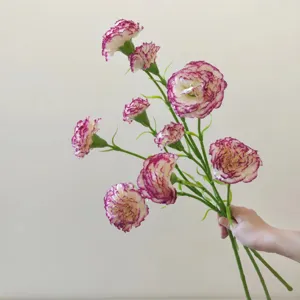 Close-up detail of artificial carnation flowers with purple edge petals, elegant decor.