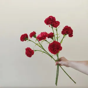 Detail of red artificial carnation silk flowers, great for home decor and wedding background.