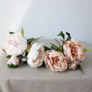 Close-up detail of artificial peony flowers silk floral arrangement for home decor