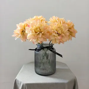 Vintage artificial dahlia flower bouquet in a ribbed glass vase, elegant home decor.