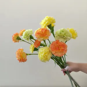 Close-up detail of artificial carnation flower bouquet, vibrant multicolored silk floral decor.