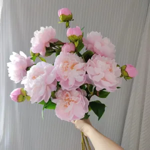 Detailed shot of pink artificial peony bouquet, realistic silk flowers for home decor and backdrop.