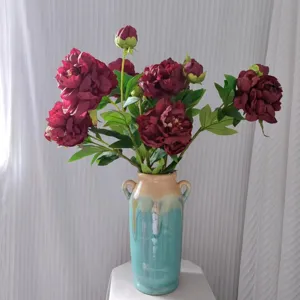 Artificial dark red peony flowers arrangement with ceramic vase for home decor item.