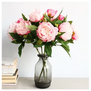 Artificial pink peony flower bouquet with glass vase for home decor and wedding arrangement.