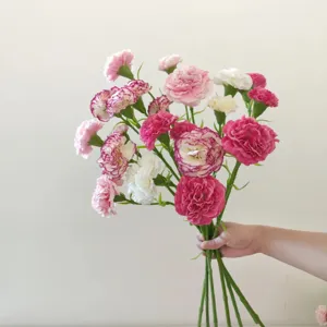 Detailed view of artificial carnation flower bouquet with vibrant multi-color blooms.
