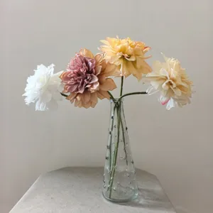 Vintage artificial dahlia flowers bouquet in glass vase for home decor and DIY crafts.
