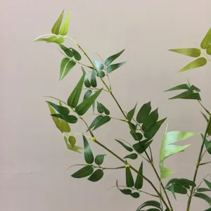 Close-up of artificial bamboo leaves, new Chinese style green plant branch for decor.