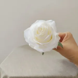 Close up detail of white artificial rose flower head, perfect for DIY crafts and floral arrangements.