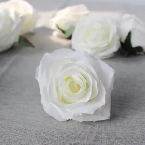 Close-up detail shot of artificial white rose flower heads, perfect for DIY crafts and decor.