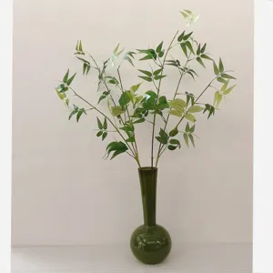 Artificial bamboo branches and fake green plants in glass vase for home decor Zen room