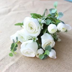 Artificial white rose bouquet with eucalyptus leaves for home decoration and DIY crafts.