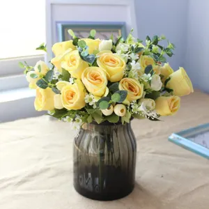 Artificial yellow rose flower bouquet with eucalyptus leaves for home decor and wedding.