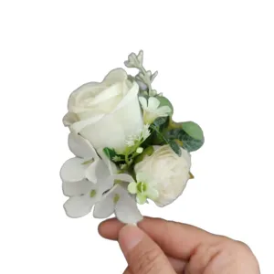 White artificial rose boutonniere for wedding groom best man, elegant corsage flower decoration.