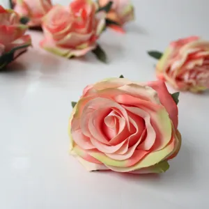 Detailed close-up view of artificial silk rose flower heads in pink gradient color for DIY crafts.