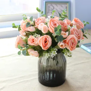 Artificial rose eucalyptus flower bouquet in glass vase for home decor DIY wedding floral arrangement.