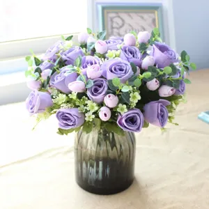 Artificial purple rose and eucalyptus bouquet in glass vase for home decor wedding arrangement