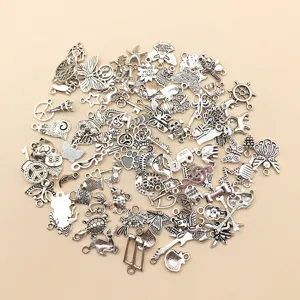 Detailed view of mixed alloy charms, assorted silver jewelry pendants for DIY crafts.