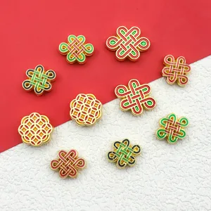 Detail view of DIY alloy gold-plated Chinese knot and coin spacer beads for handmade bracelets.