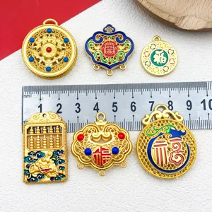 Detailed view of Chinese style gold alloy DIY jewelry charms, locks and abacus pendants.