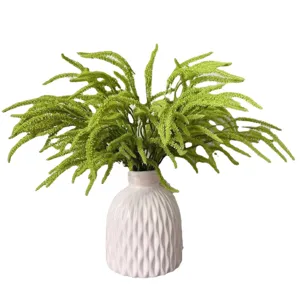 Artificial fern plant in white ceramic vase, lifelike green foliage for home decor.