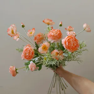 Artificial silk flower bouquet detail view, peach ranunculus and poppy for home decor