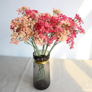 Artificial colorful baby breath flower bouquet in glass vase for home decor wedding.