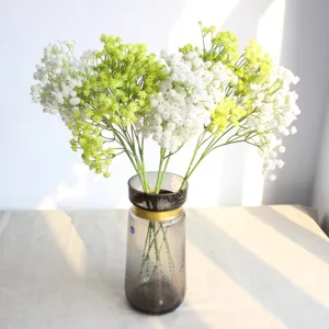 Detailed view of artificial gypsophila flowers in a stylish glass vase, perfect for home decor.