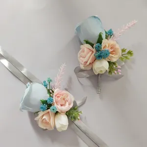 Artificial rose boutonniere detail shot featuring blue and pink fabric flowers with silver ribbon.