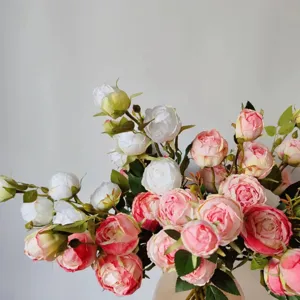 Detail of artificial silk roses, multi-layered pink and white blooms for decor and props.