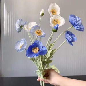 Artificial poppy flower detail showing multi-head blue and white velvet floral arrangement.
