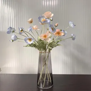 Artificial poppy silk flowers bouquet in glass vase, realistic faux floral decor for home.