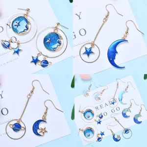 Blue and gold celestial earrings set featuring moon, star, and planet designs for women.