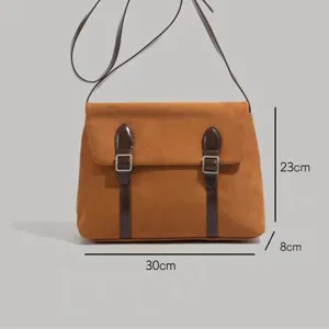 Detailed view of brown vintage messenger bag showing dimensions and double buckle straps.