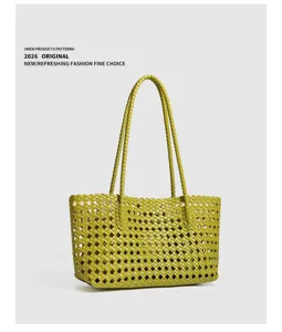 Green woven leather tote bag detail view, minimalist casual shoulder bag design for daily wear.