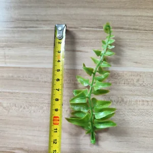 Artificial green PVC fern leaf DIY craft floral arrangement accessory for hat and corsage decor.