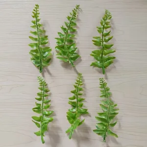 Green PVC artificial fern leaves detail view for DIY floral crafts, corsage, and hat decoration.