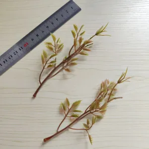 Small green PVC artificial leaf branch detail shot for DIY craft hat and corsage decor.