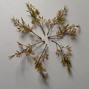 Detailed shot of green artificial leaves, perfect for DIY crafts, corsages, and floral decor.