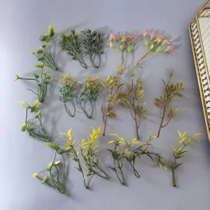 Detail view of miniature artificial green plant leaves, perfect for DIY crafts and floral design.