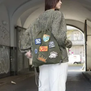 Green drawstring backpack for women casual travel, stylish sackpack with patches, large capacity.