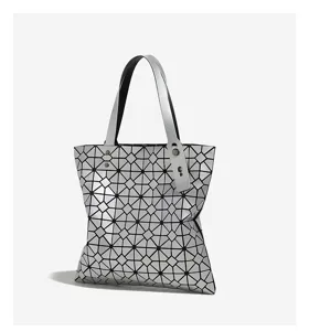 Detailed view of silver geometric diamond pattern tote bag showing unique texture and structure.