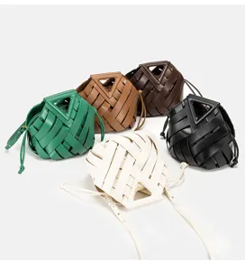 Detail view of stylish woven bucket bag with unique triangle handle and multi-color options.