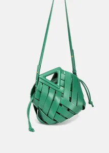 Green woven leather handbag detail featuring a distinctive rigid triangular handle and drawstring.