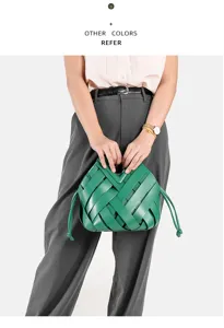 Green woven handbag with chunky leather strips, stylish shoulder and crossbody bag for women.