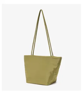 Minimalist olive green hobo shoulder bag detail, casual cloth handbag close-up shot.