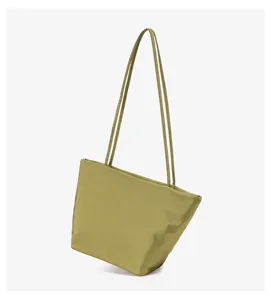 Detail view of casual olive green nylon shoulder tote bag showing delicate strap texture.