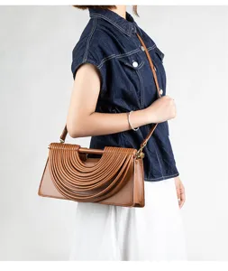 Stylish brown leather crossbody shoulder bag with unique pleated wavy design detail.